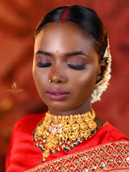 A serene close-up focusing on the bride's makeup. The soft smokey eye and the matte lipstick create a look of understated elegance.
