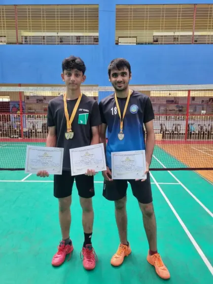 Zehn Masani and his partner with their gold medals and certificates after winning the Boys Doubles U17 event at the CISE Zone D Championship.
