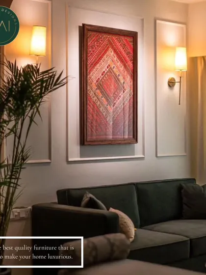 A dark green sofa placed in a warmly lit room, demonstrating how our furniture can anchor a space and create a cozy, luxurious ambiance. We work with clients to select colors and fabrics that complement their overall interior design.