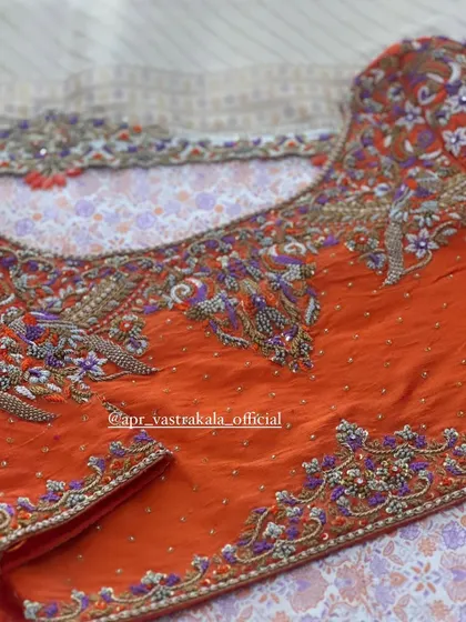 The back of the orange blouse, with a keyhole cutout.