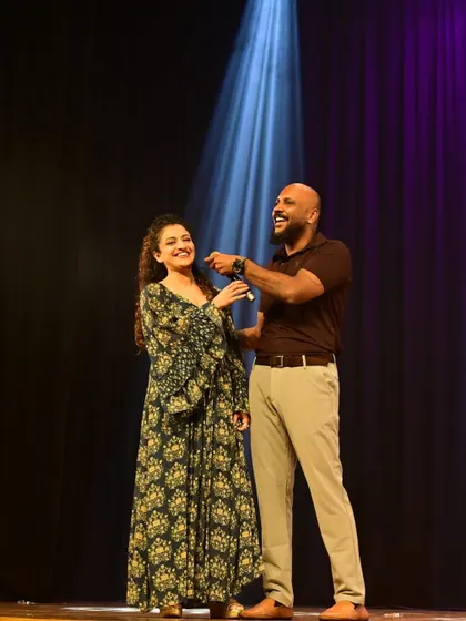 The director and a guest on stage during our "Moments of Magic" showcase. This event brought together over 1200 performers and 4000 audience members across two cities.