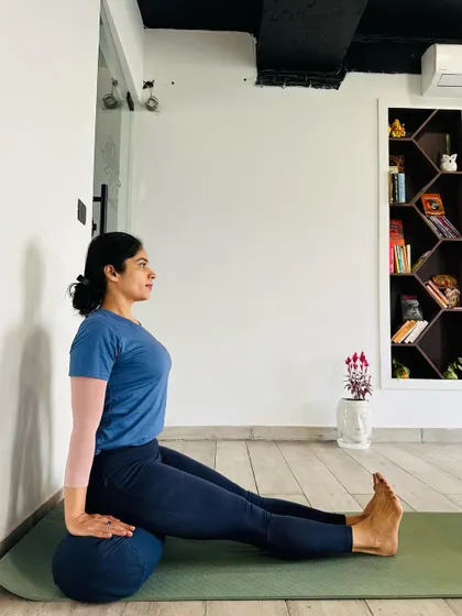 The type of support used in a seated pose matters. A soft bolster allows the buttocks to sink, providing lateral support, which can be comforting for some. We choose props based on the specific need of the student's body.