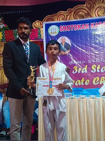 Here I am with a young champion who holds his trophy and medal. It is my greatest joy as a coach to see the pride and sense of accomplishment on my students' faces.