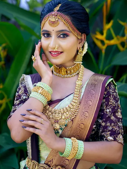 This pose shows the details of the embroidered blouse and how the saree is draped to keep the design visible while maintaining a clean look.