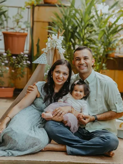 The full family enjoying the beautiful outdoor setup for their baby's half-birthday. These are the relaxed, happy moments I love to capture.