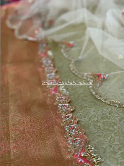 A close-up of the embroidered border, showing the fine craftsmanship and use of multiple techniques to create a luxurious edge.