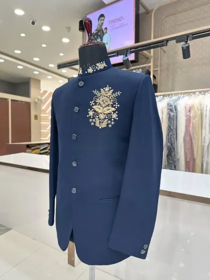 Side view of the navy blue Jodhpuri, showing the placement of the gold zardosi emblem.