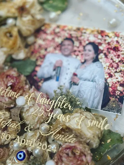 Another view of the beautiful anniversary keepsake. The combination of the photo, preserved flowers, and custom text creates a truly heartfelt and personal gift.