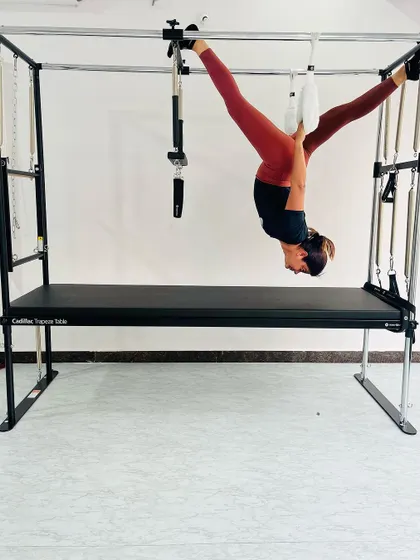 This client is performing a suspended split, an advanced move that challenges the limits of flexibility and strength.