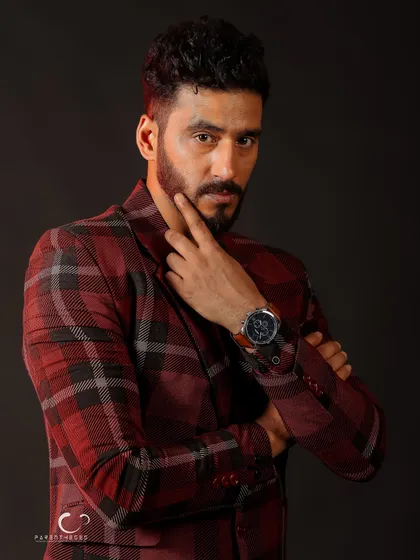 A classic, confident pose that is perfect for a professional portfolio. The lighting is sharp, highlighting his features and the texture of the suit.
