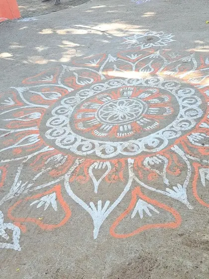 A beautiful rangoli design on the ground, part of the festive decorations for the 'Roti Habba'.