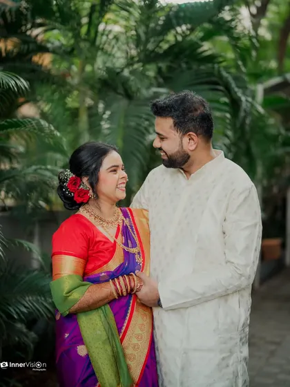 A candid moment of laughter and love. The couple shares a joke, their genuine smiles making this a heartwarming and authentic engagement photo.