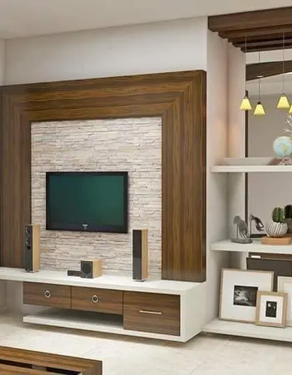 This entertainment center features a bold, heavy wood frame around a stone-textured back panel. The design also includes a partition with display shelves, helping to define the living area in an open-plan space.