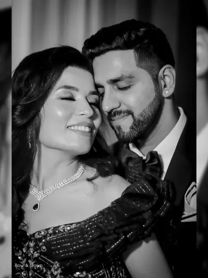 A beautiful black and white portrait of a couple in a tender embrace. This shot from their reception is full of romance and quiet intimacy.