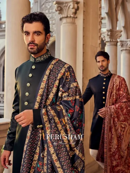Inspired by the blend of cultures in royal weddings abroad, these ensembles embody timeless craftsmanship. The deep green and black bandhgalas are paired with intricately woven shawls for a regal charm.
