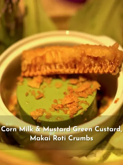 A creative dish from the 'Sounds of India' menu: Corn Milk & Mustard Green Custard with Makai Roti Crumbs and a piece of honeycomb.