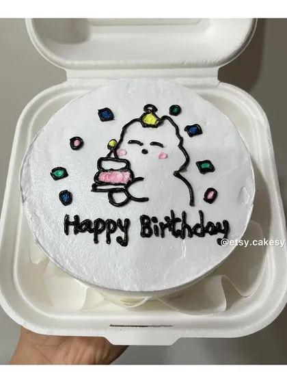 A cute character holding a mini cake, drawn on a bento cake for a birthday.