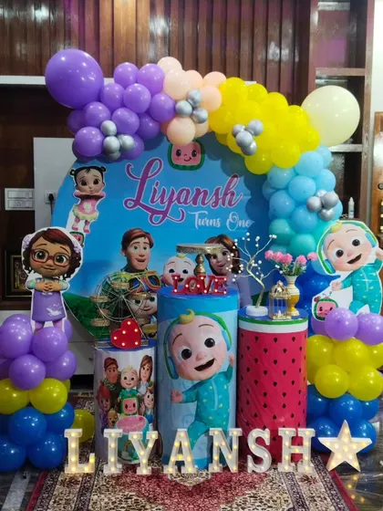 Our Cocomelon theme is a big hit with toddlers. This colorful setup for Liyansh's first birthday includes all the favorite characters, a vibrant balloon arch, and themed pedestals.