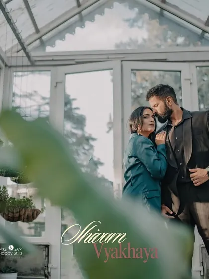 A tender moment shared amidst the greenery of a Mussoorie greenhouse. This shot uses foreground elements to create a sense of intimacy, as if we are peeking into a private, romantic world.
