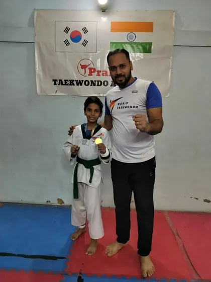 A green belt student with his well-earned gold medal.