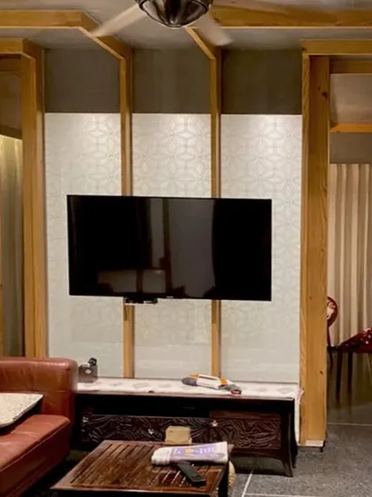 The 'lantern' partition in the Lucknow penthouse also serves as a feature wall for the television. This integration of technology into a handcrafted architectural element ensures that function does not compromise the overall design concept.