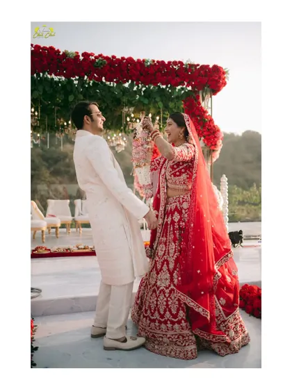 The playful varmala exchange. This action shot captures the fun and excitement of one of the most beloved wedding rituals, with the couple sharing a laugh.
