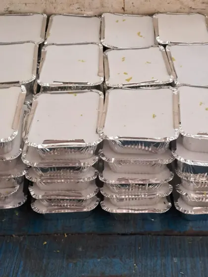 Stacks of freshly packed meals, sealed and ready for dispatch. We can handle high volume orders with ease.
