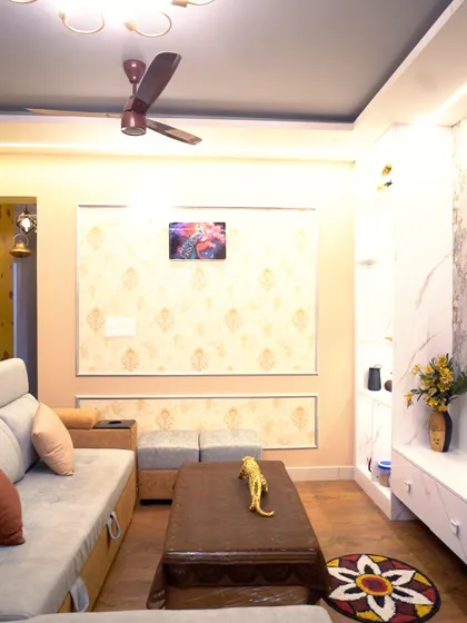 A view of the living room showing the mix of textures and patterns, from the wallpaper to the floor rug. The space feels layered, personal, and inviting.