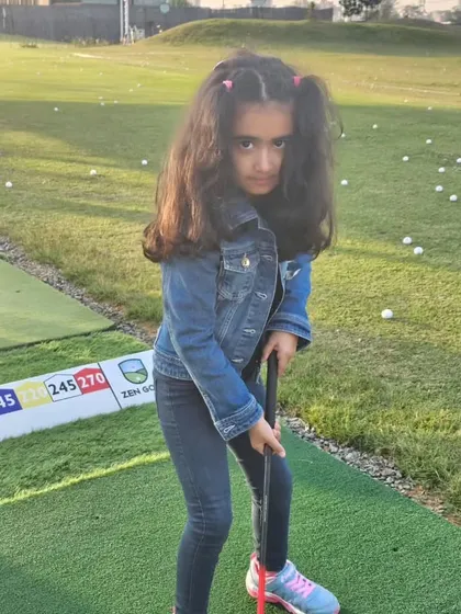 This young player is all set for her shot. I love seeing the determination and focus in my junior golfers as they learn and grow in the sport.