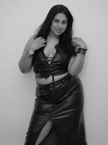 Adjusting my hair in this shot from the black and white leather photoshoot. It's a candid and confident moment.