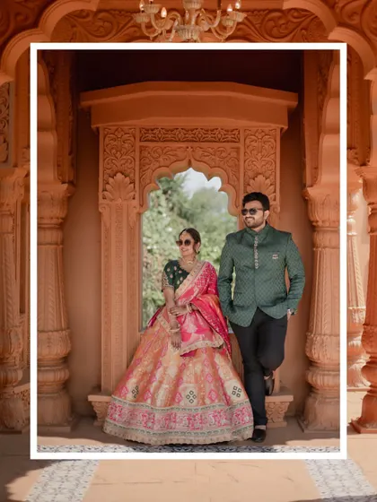 A stylish pre-wedding portrait of the couple posing in a carved stone window, blending modern attitude with traditional architecture.