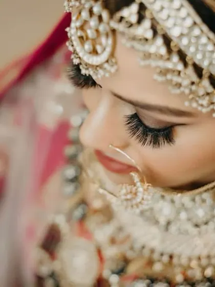 This artistic close-up showcases the precision of our bridal eye makeup. The dramatic false lashes and perfectly blended eyeshadow create a deep, captivating look that is essential for bridal photography.