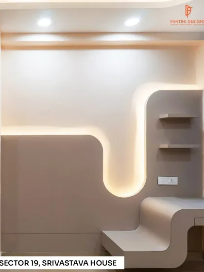 A close-up of the custom-designed study and display unit in the Srivastava House bedroom, featuring curved lines and integrated backlighting.
