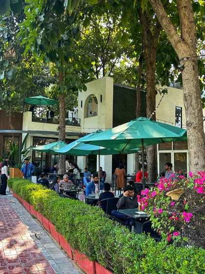 A wide shot of our bustling cafe patio, a popular spot for both golfers and food lovers to enjoy the outdoors.