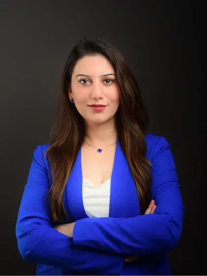 A professional studio portrait for a doctor. The clean, dark background and direct gaze create a sense of trust and competence, essential for a medical professional's branding.