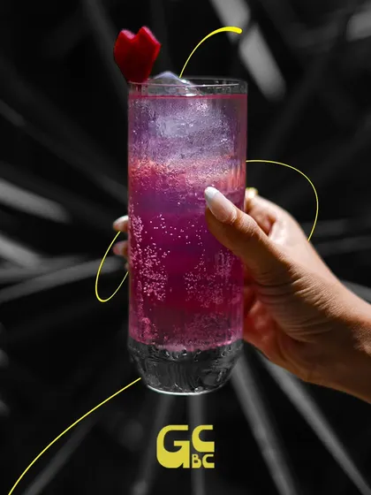 A vibrant purple cocktail that's sure to brighten your day. One sip is all it takes.