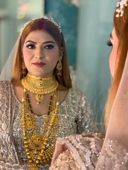 A mirror shot of the reception bride, reflecting her beauty and the intricacy of her jewelry.