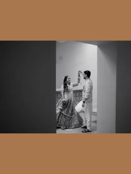 An artistic, framed shot in black and white of the couple sharing a dance.