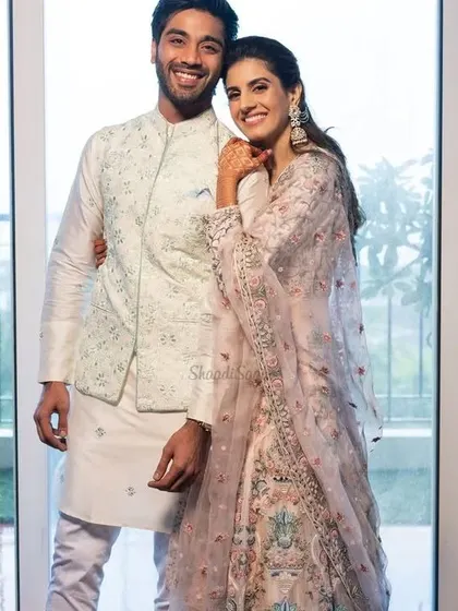 Soft pastels for a day event. The bride's floral lehenga is beautifully paired with the groom's simple white kurta and matching embroidered Nehru jacket.