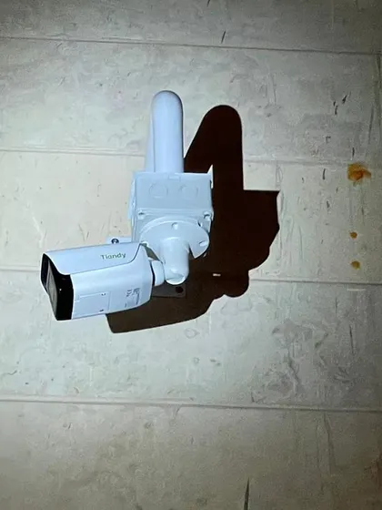 A Tiandy 5MP starlight camera installed at night. The camera's own IR lights illuminate the area, as you can see from the shadow.