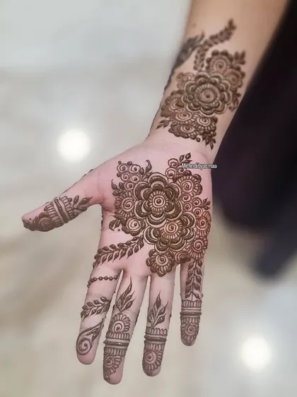 A lovely floral piece on the palm and wrist. This is a great option for someone who wants a design that's not too heavy.