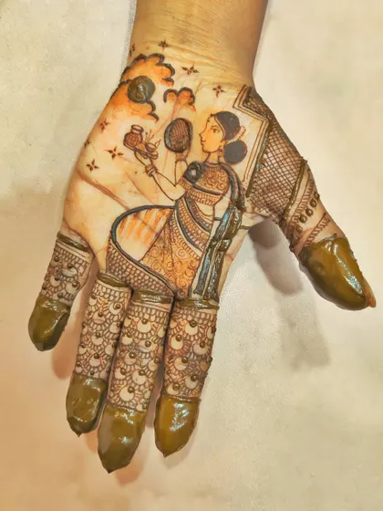 I focused on a single, large figure for this Karwa Chauth piece. The woman holding a pot and looking at the moon fills the entire palm, with delicate details in her saree and jewelry.