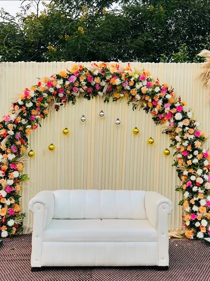 The same minimalist backdrop, now transformed with a beautiful arch of colorful flowers. This shows how we can adapt a single design element to different styles.