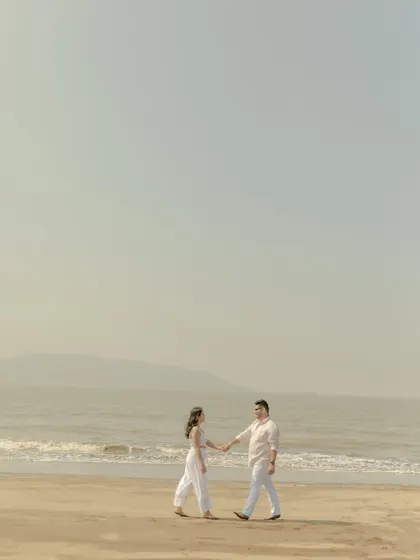 A wide shot emphasizing the scale and tranquility of the beach. This minimalist approach creates a serene and cinematic feel for your pre-wedding photos.