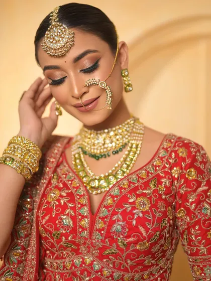 A soft, downward gaze highlights the beautifully blended eyeshadow and the radiant glow of the skin. This is a classic and elegant bridal portrait.