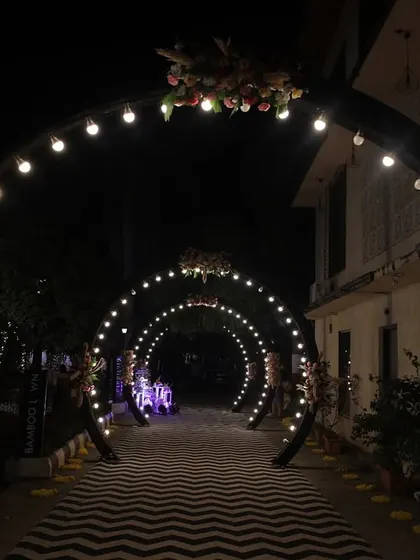 The full view of the light-bulb archway, creating a tunnel of light for the couple's entrance. This is a simple yet highly effective way to make a grand statement.