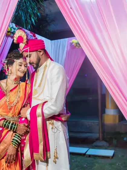 A romantic portrait of the couple under the mandap, embracing in a moment of quiet celebration.