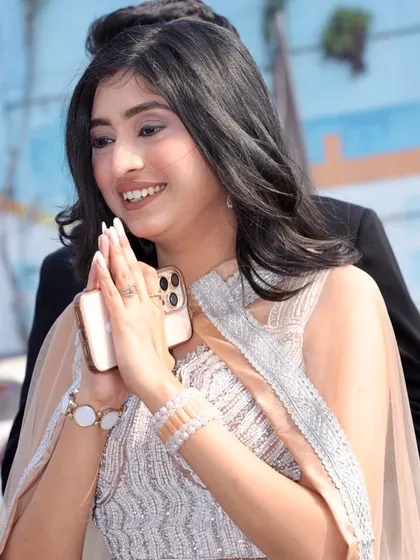 A candid shot of a happy client ready for an event. Her makeup is natural and glowing, perfect for any celebration.