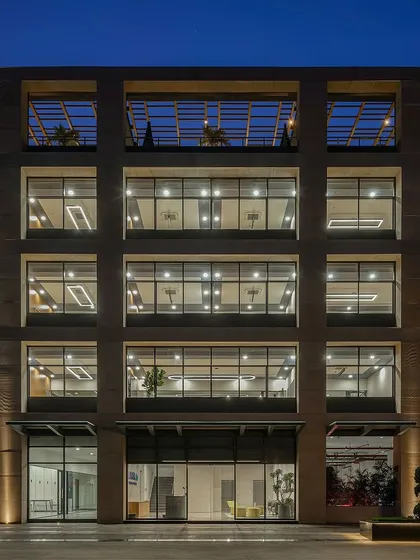 The gridded facade of Laurus Labs creates a strong architectural identity, with deep-set windows that provide shade and large floor plates for flexible office layouts.