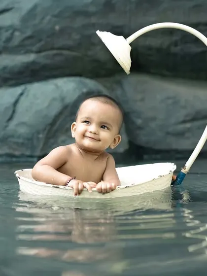 A calm and happy baby enjoying a boat ride in our little pond. This is a unique and beautiful setup for a water-themed shoot.